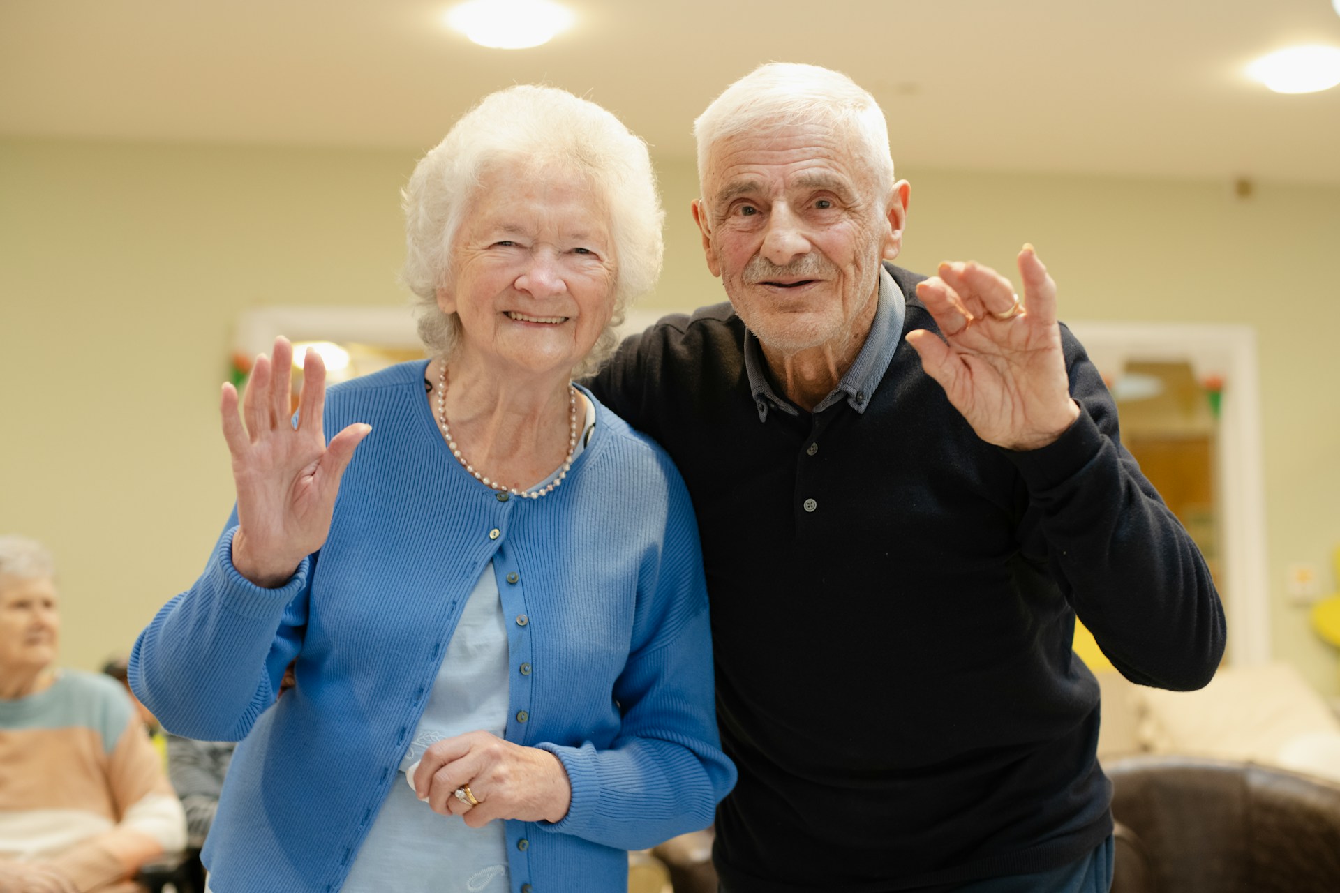 An older couple laughing together outdoors